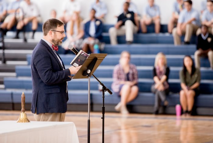 man speaking at microphone